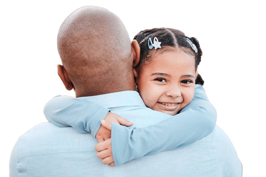 A father faces away while his smiling daughter gives him a hug.