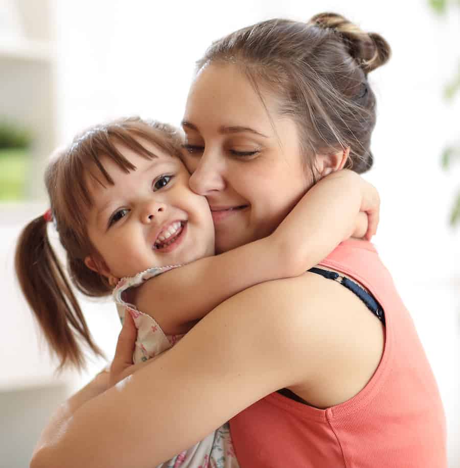 A happy mother and daughter hugging