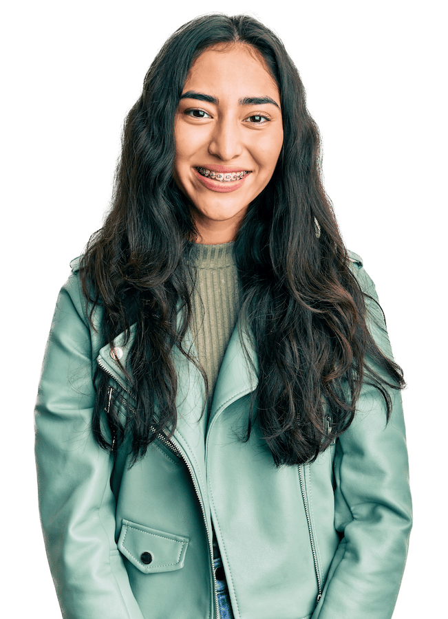 A teen girl smiles at the camera.