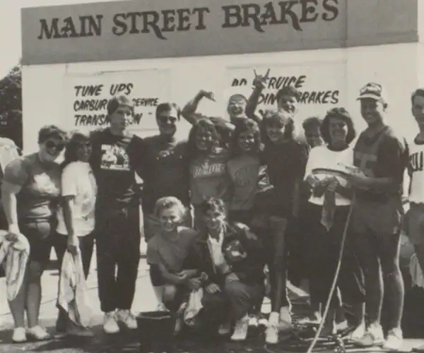 Students pose outside Main Street Brakes, Greenfield H.S. Catamount, 1987