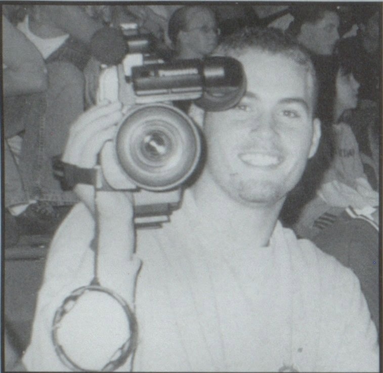 Cameraman Clay Partin takes a break from taping a girls volleyball game. Photo B. Dyer, Eastern Hancock, 2001