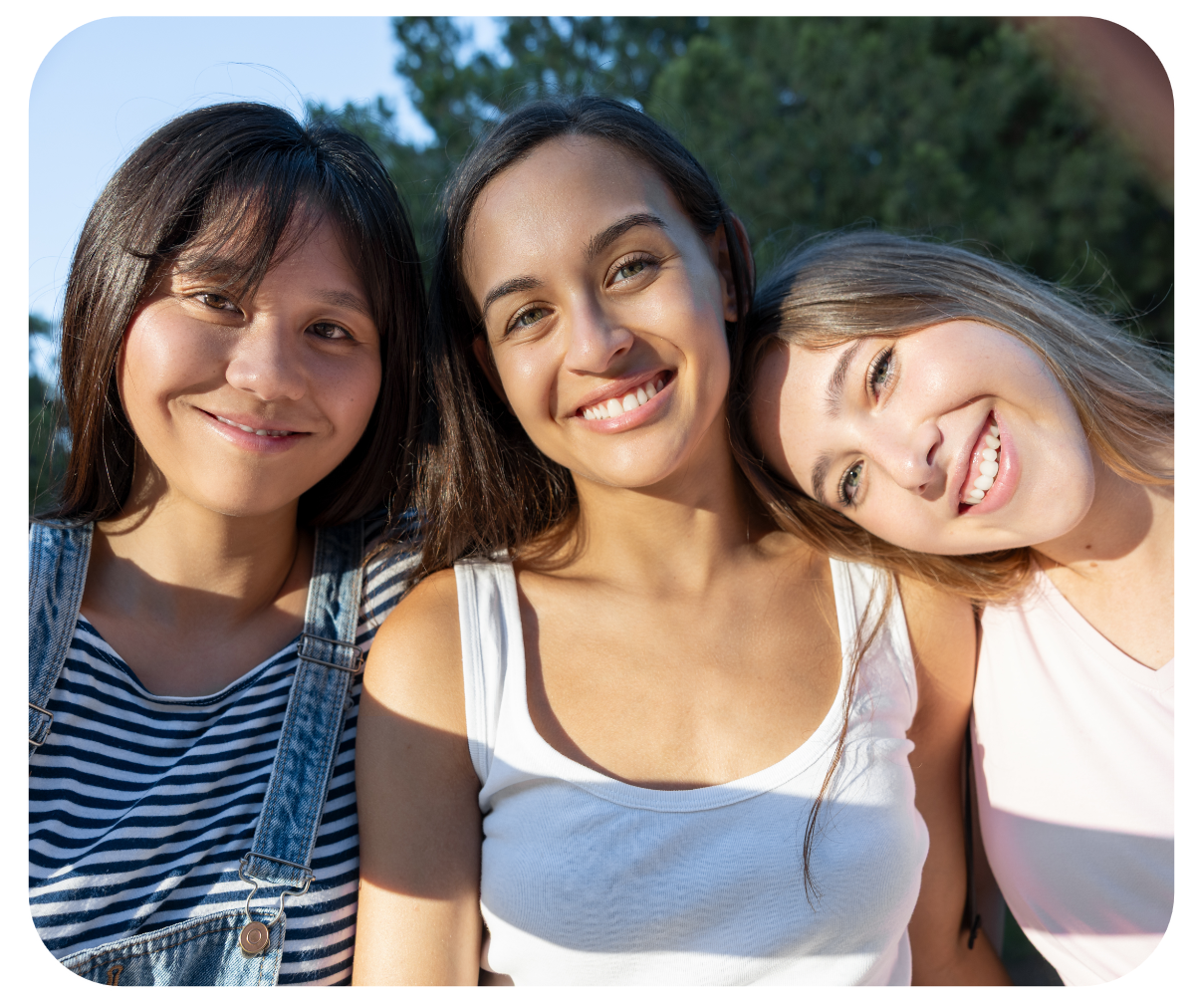 Three teen girls pose in a selfie